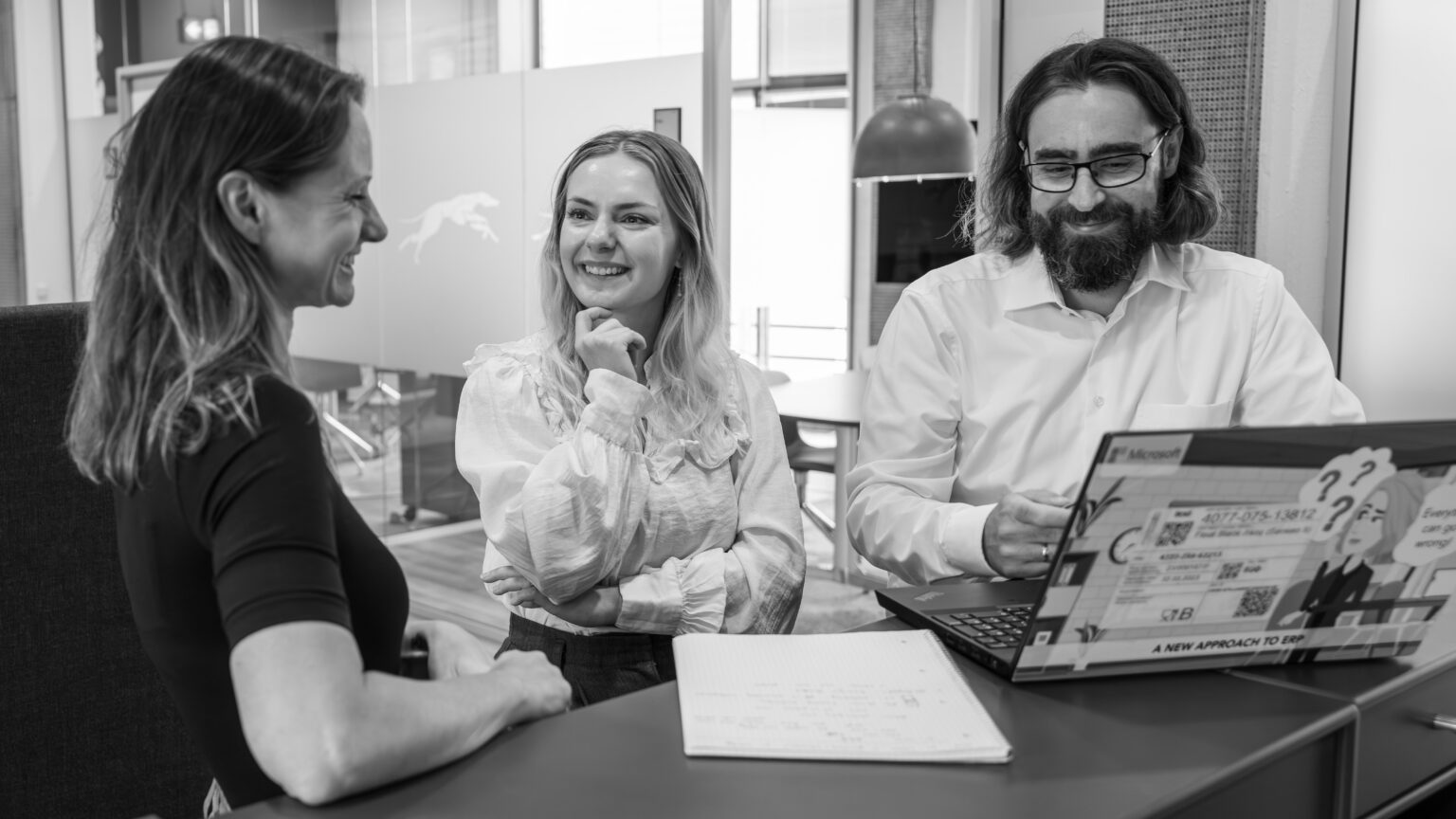 three people working at an office